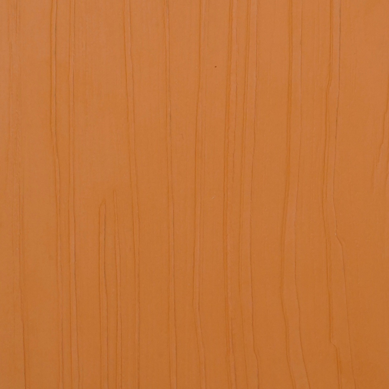 PL-204 Terra Orange Woodgrain laminate with textured vertical grain and warm terracotta tone for modern interior design by Plyneer.